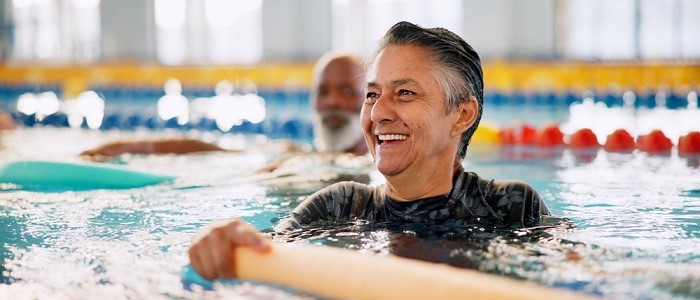 Older men exercising together in a swimming pool