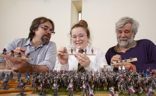 Left to Right: Professor Tony Pollard, Professor of Conflict History and Archaeology at the University of Glasgow; Lucy Wallace, S3 Pupil, Clydebank High School and John Hamilton, Volunteer for the Model Making Group at Erskine, helping to paint some of the 22,000 28mm figures to be used in Great Game: Waterloo Replayed table top war game. Photo Credit Martin Shields