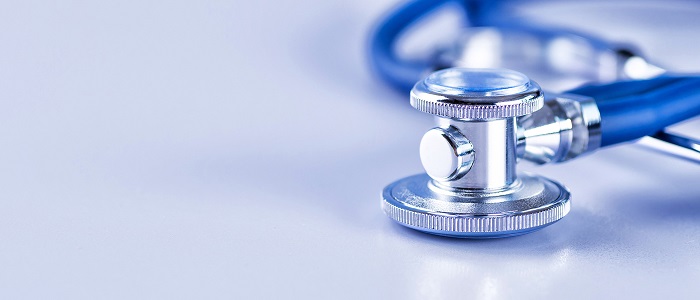 Photo of a stethoscope with a blue and white background