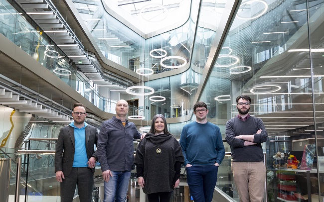Photo of five people standing in an atrium of a modern building. Left to right: Professor Ben Colburn; Dr Derk Brown; Professor Fiona Macpherson; Professor Neil McDonnell and Calum Hodgson photographed in the University of Glasgow ’ s Advanced Research Centre (ARC). Photo credit: Martin Shields
