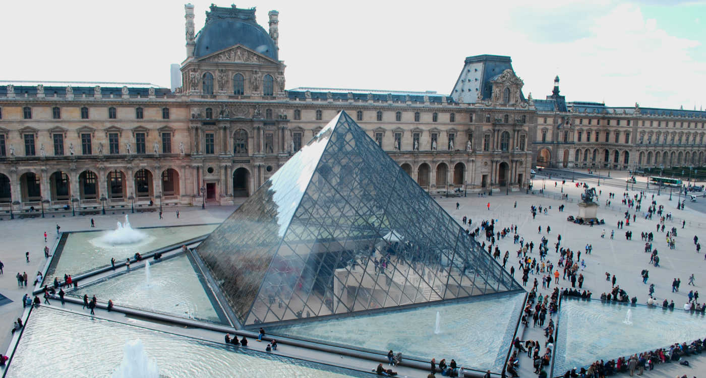 Exterior view of Louvre showing the old building and the glass pyramid [Photo: Shutterstock]