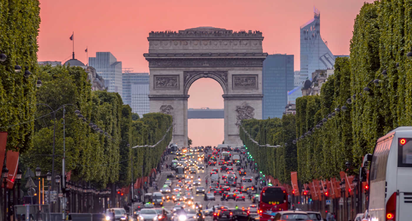 Champs Elysees and the Arc de Triomphe during a pink sunset [Photo: Shutterstock]