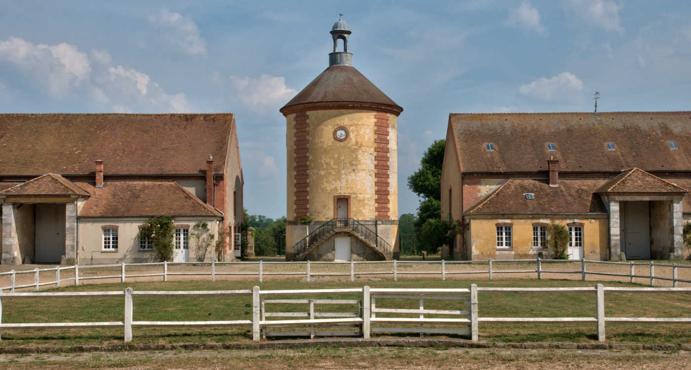 Outside of a tower and barn-like buildings at Bergerie Nationale of Rambouillet [Photo: Shutterstock]