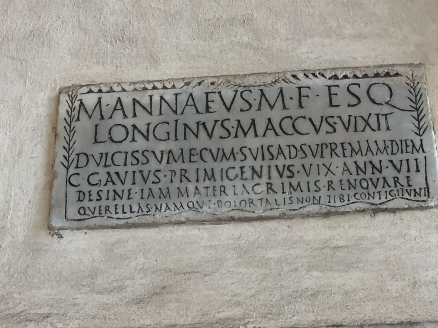 Epitaph (first century AD) of the actor M. Annaeus Longinus, of the Esquiline tribe, who played the role of the Atellane character Maccus “Mr Stupid”. It was discovered in the catacombs of SS Gordianus and Epimachus in Rome, and is now placed in the walls of the portico of Santa Maria in Trastevere, Rome (CIL 6.10105 = ILS 5219 = CLE 823) (photograph taken by C. Panayotakis).