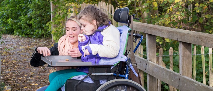 picture of child in wheelchair with mum