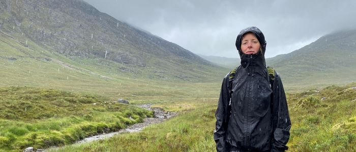 Photo of Georgia McDowall standing in countryside on a very rain day