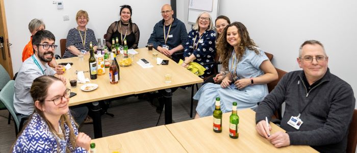 A group of staff sitting round tables at the SHW spring fling 2023