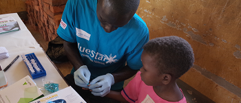 Child receiving origami diagnostic test