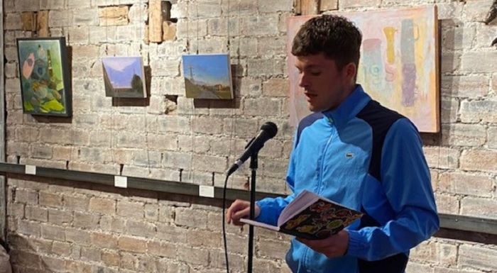 Photo of Craig Houston reading from a book