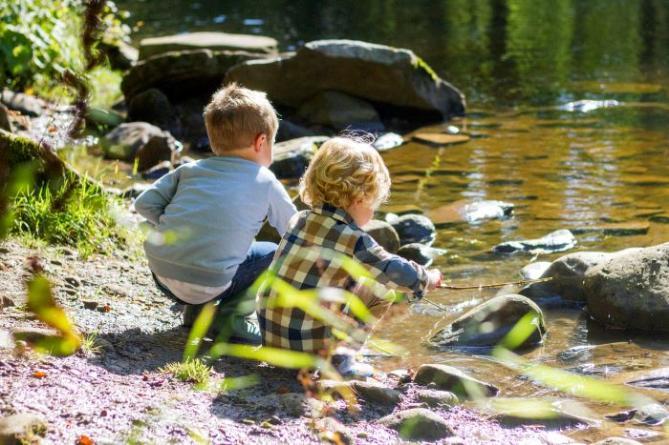 Young children playing at river