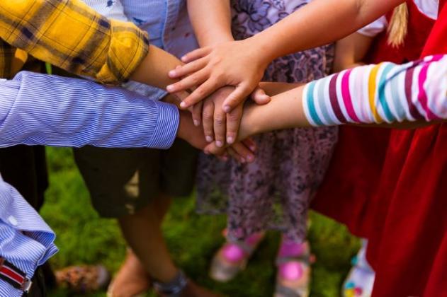 Children joining hands together