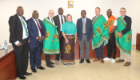 A University of Glasgow and Scottish Government Delegation stood in a line wearing traditional Zambian attire alongside University of Zambia