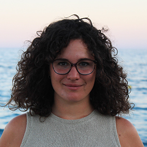 Profile photo of Dr Eleonora Brandimarti, Lecturer in Economics, view of the ocean in the background