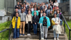 Participants from the summer school stood together as a group on the steps outside the UofG Boyd Orr Building