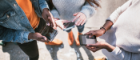 A group of adolescents holding mobile phones