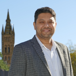 Profile photo of Dr Abrar Ali Saiyed, outside with the University of Glasgow tower in the background