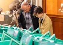 Image of a man and a boy looking at exhibits in containers at the Graham Kerr Building