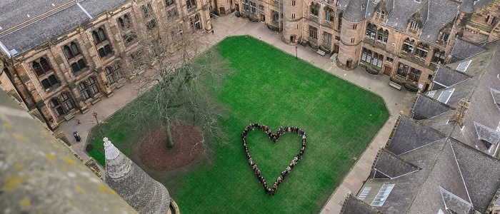 Students standing in quad in shape of a heart