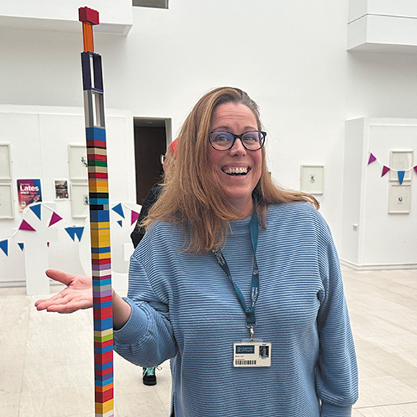 DAO staff member with a LEGO tower