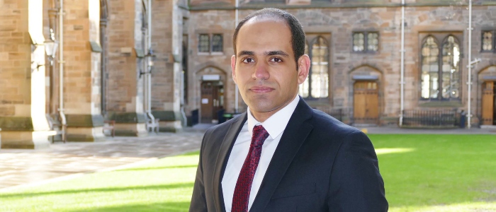 Dr Rami Al-Sharif standing in the cloisters