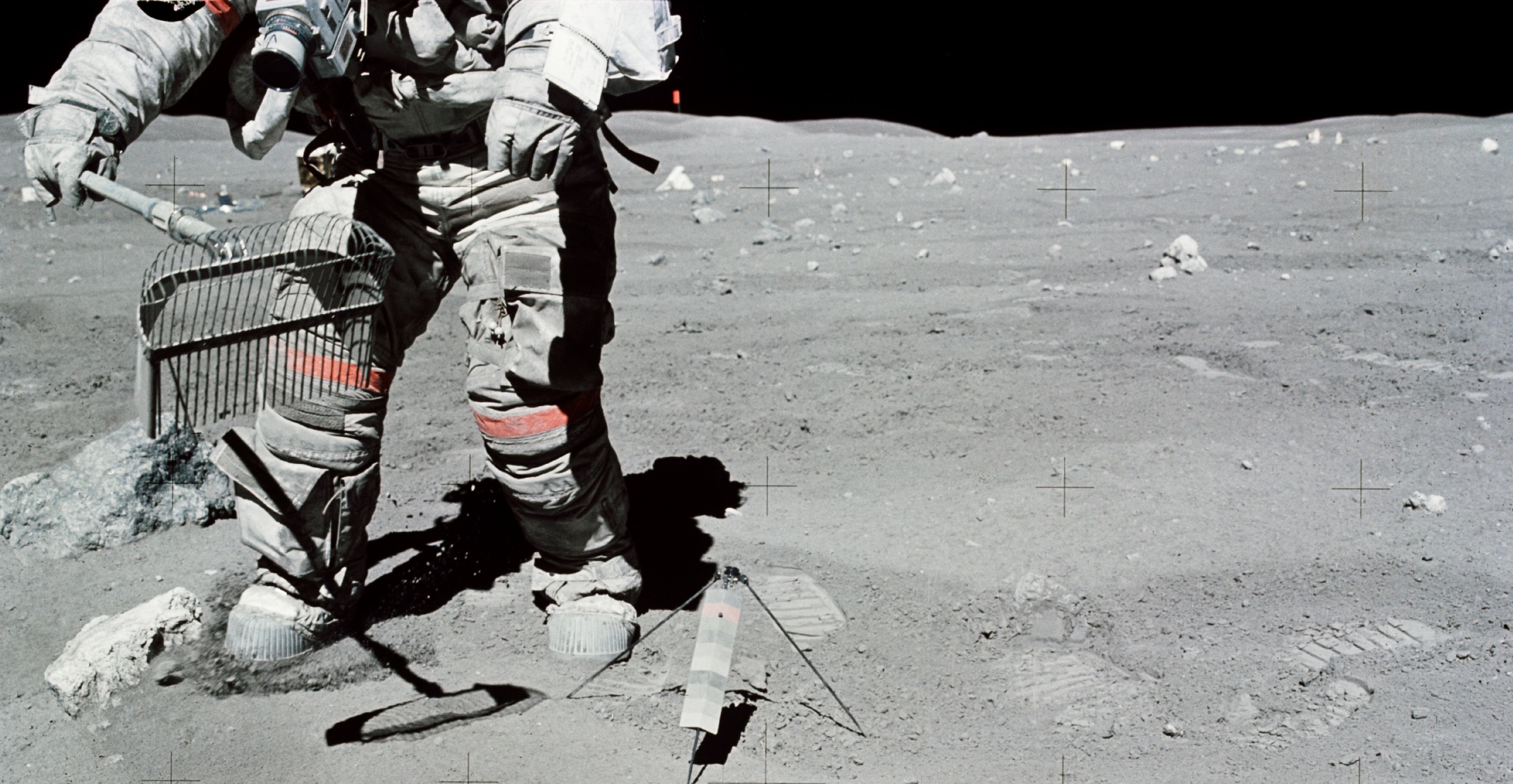 Astronaut John W. Young collects samples of lunar regolith. (Photo credit: NASA)