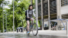 A person on a bicycle riding through the Glasgow University Campus