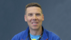 A head and shoulders shot of Professor Andy Roe against a blue background