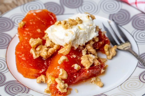 Turkish pumpkin dessert topped with clotted cream and crushed walnuts