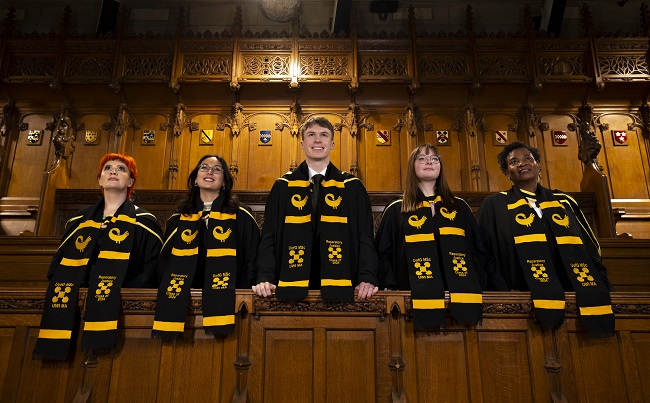 L to R Reparatory Justice Masters graduates Nicole Whyte; Fer Ortiz Vivas, Fergal O’Donohoe;  Fanny Olsson and  Cordelia Asamoah standing in their graduation gowns in the University of Glasgow Chapel. Credit Martin Shields