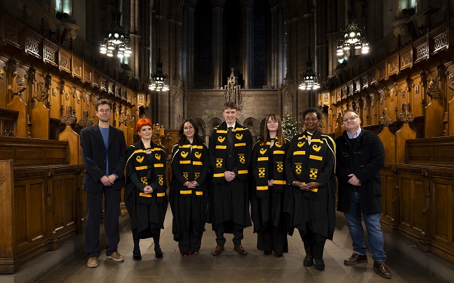 L to R UofG Historian Dr Jelmer Vos; Reparatory Justice Masters graduates Nicole Whyte; Fer Ortiz Vivas, Fergal O’Donohoe;  Fanny Olsson and  Cordelia Asamoah and UofG Historian Dr Stephen Mullenstanding in their graduation gowns in the University of Glasgow Chapel. Credit Martin Shields