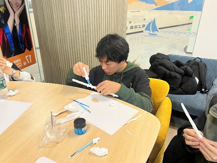 A student at Glasgow College, UESTC focuses intently on making his wand