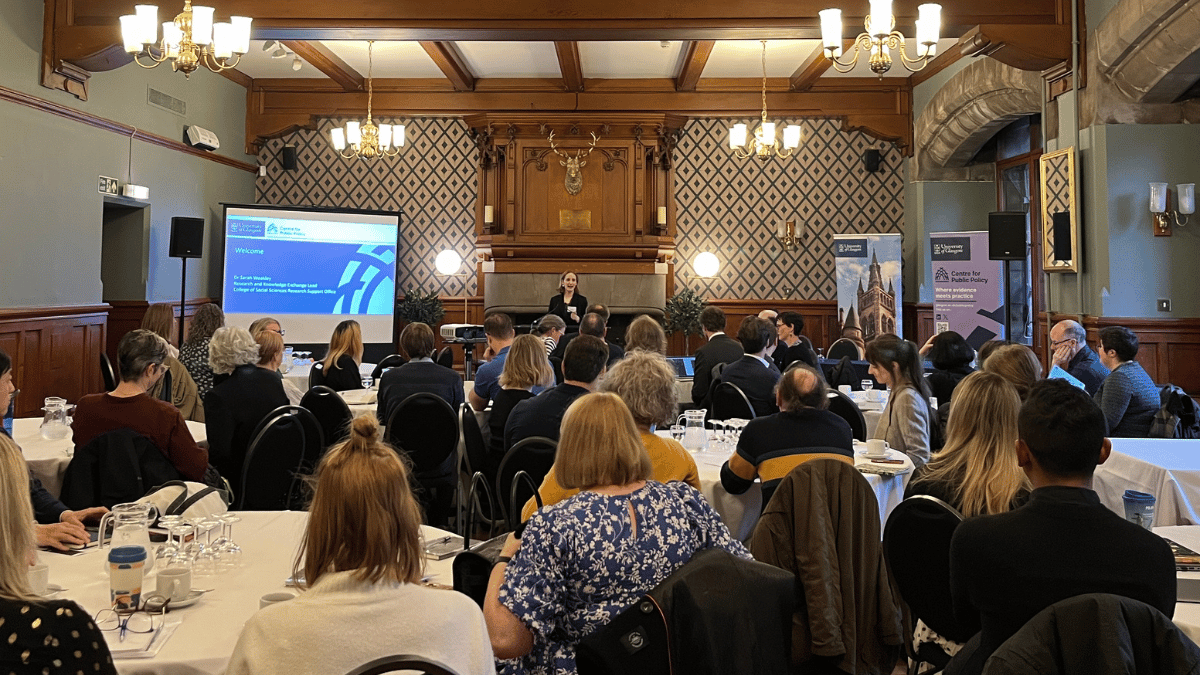 A photo of Dr Sarah Weakley addressing a crowded room at the University