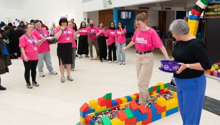 Woman walking on trail of Lego bricks