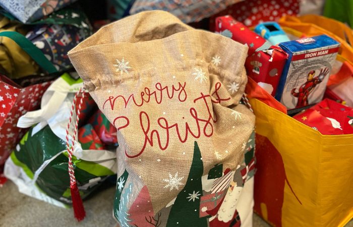 A bag filled with Christmas presents