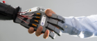 Robot hand shaking human hand