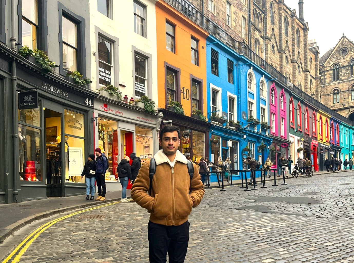 Person pictured in front of the colourful buildings of Victoria Street, Edinburgh