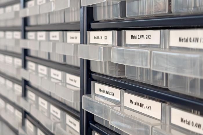 Close up of small plastic drawers containing various making components