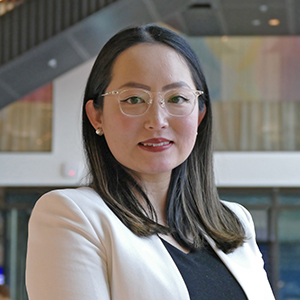 Dr Reika Igarashi profile photo in the Atrium of the Adam Smith Building, University of Glasgow