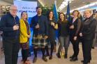 Seven staff members, Scotland House banner, EU flags