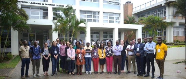 A group of researchers from Glasgow and Malawi are standing outside a university building