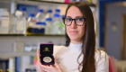 Professor Lilach Sheiner pictured in the lab holding the C.A. Wright medal in an open presentation case