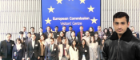 Group picture of International Relations students in front of European Commission with headshot of smiling man