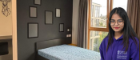 View of internal student accommodation room with headshot of woman in jumper on the right side