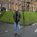 student in front of university main building