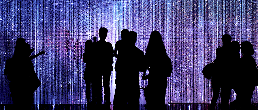 People in a dark room with sparkle lighting effect.