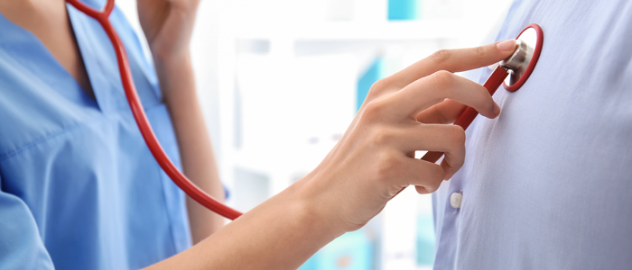 Photo of doctor listening to person's heartbeat