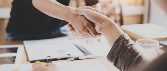 Photo of 2 women shaking hands