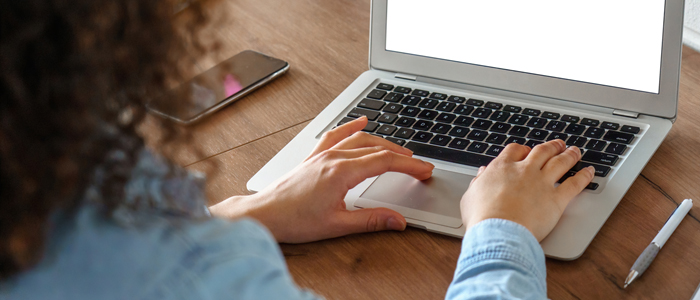 Photo of back view of person working on laptop