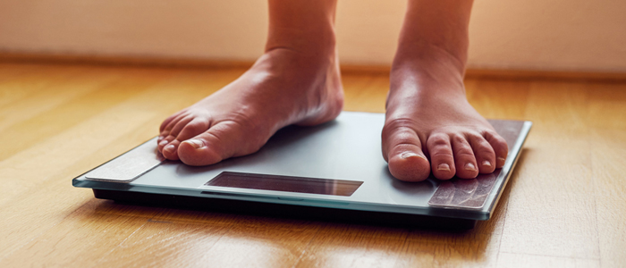 Photo of person standing on weighing scales