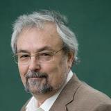 Prof Robin Dunbar, Oxford university. Grey hair man in brown jacket and white shirt